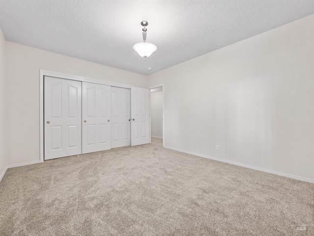 1415 E Lake Crk, Meridian, ID 83642 - unfurnished bedroom with carpet floors, baseboards, a closet, and a textured ceiling