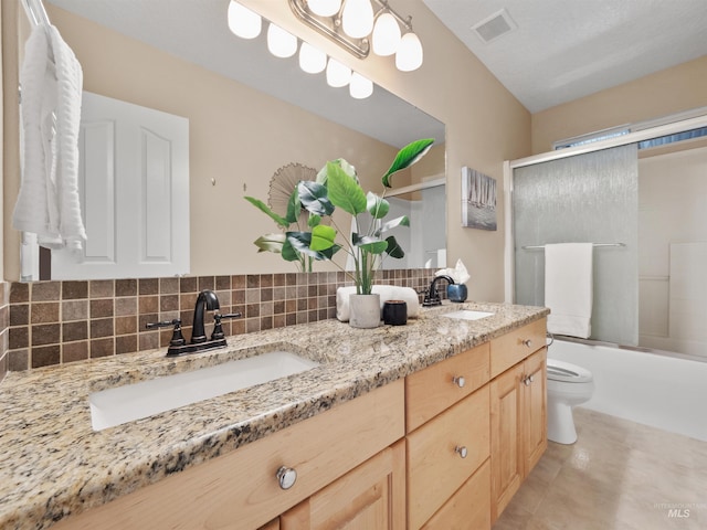 1415 E Lake Crk, Meridian, ID 83642 - bathroom with double vanity, toilet, bath / shower combo with glass door, tasteful backsplash, and tile patterned floors