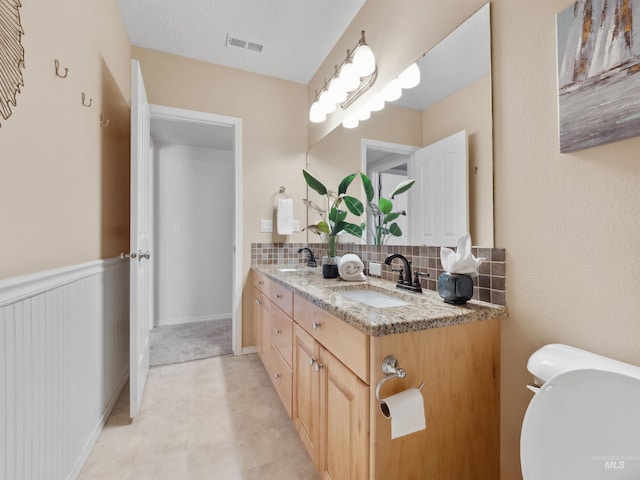 1415 E Lake Crk, Meridian, ID 83642 - bathroom with toilet, decorative backsplash, and double vanity