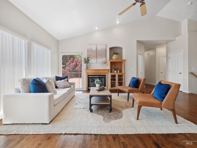 1415 E Lake Crk, Meridian, ID 83642 - living area with wood finished floors, a ceiling fan, a glass covered fireplace, and high vaulted ceiling