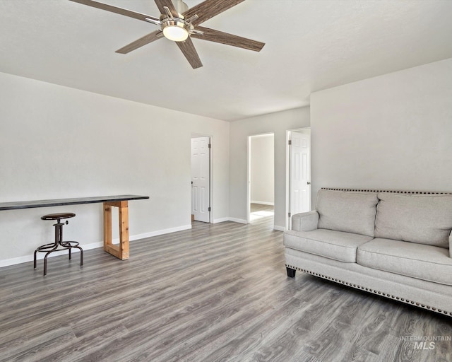 504 E 7th St, Emmett, ID 83617 - unfurnished living room with wood finished floors, ceiling fan, and baseboards