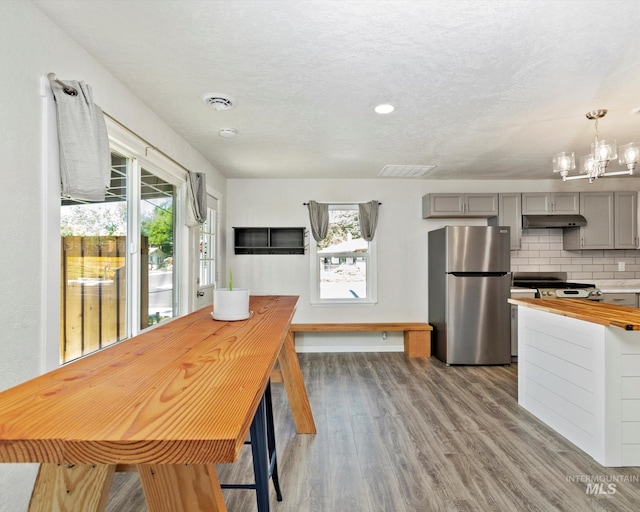 504 E 7th St, Emmett, ID 83617 - dining area with healthy amount of natural light, wood finished floors, a chandelier, and baseboards