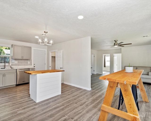 504 E 7th St, Emmett, ID 83617 - kitchen with wooden counters, dishwasher, open floor plan, a center island, and a chandelier