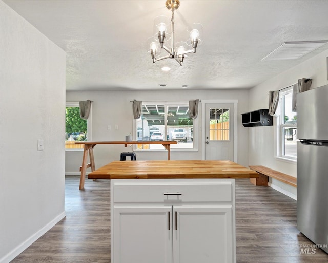 504 E 7th St, Emmett, ID 83617 - kitchen featuring freestanding refrigerator, butcher block countertops, baseboards, a chandelier, and dark wood-type flooring