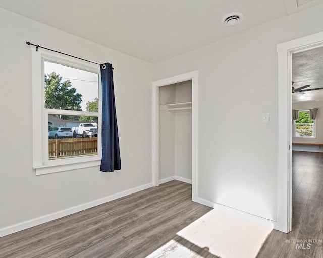 504 E 7th St, Emmett, ID 83617 - unfurnished bedroom featuring wood finished floors, baseboards, and a closet
