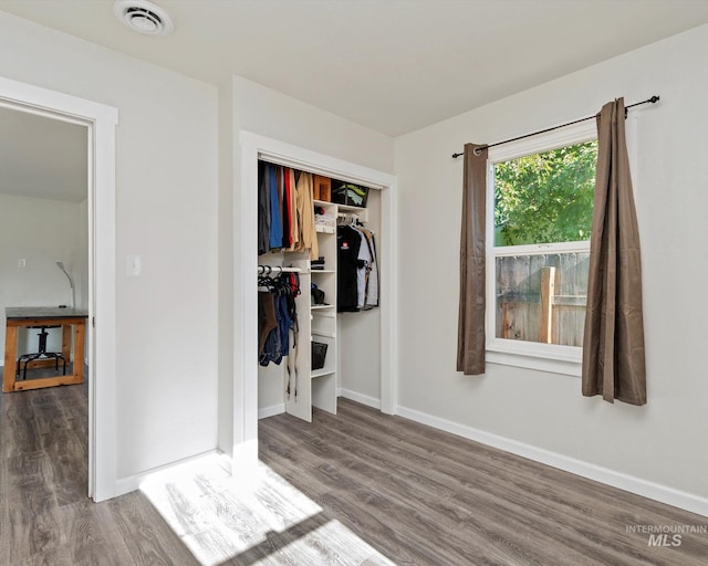 504 E 7th St, Emmett, ID 83617 - unfurnished bedroom with wood finished floors, baseboards, and a closet