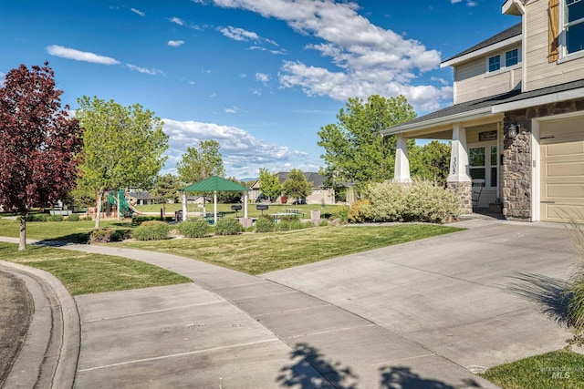 exterior space featuring a gazebo, a playground, and a garage