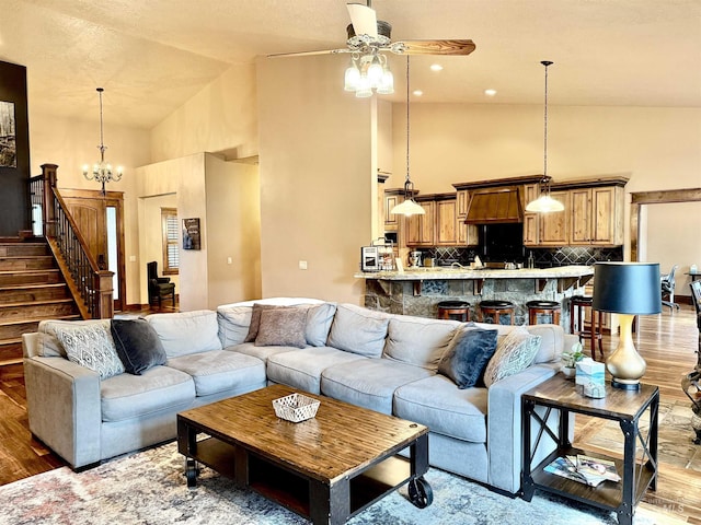20 Shore Crest Ct, Donnelly, ID 83615 - living area with high vaulted ceiling, ceiling fan, stairway, wood finished floors, and a chandelier