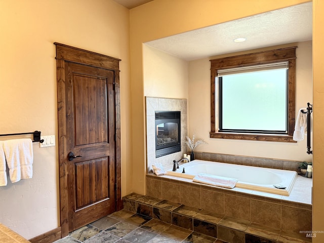 20 Shore Crest Ct, Donnelly, ID 83615 - full bath with a garden tub, stone finish floors, and a tile fireplace
