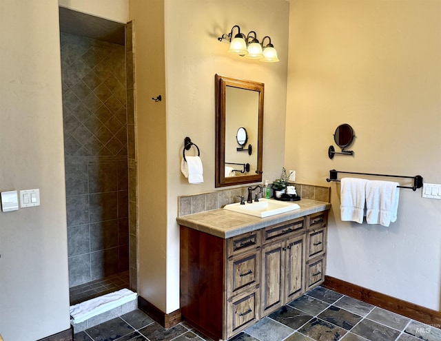 20 Shore Crest Ct, Donnelly, ID 83615 - bathroom with vanity, baseboards, tiled shower, and stone finish flooring