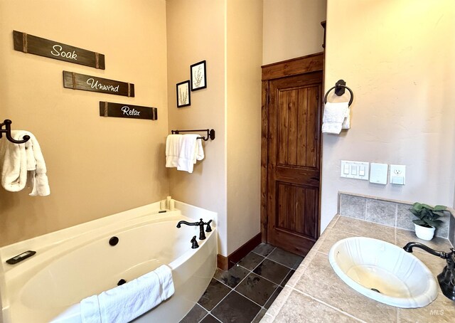 20 Shore Crest Ct, Donnelly, ID 83615 - bathroom with a garden tub, tile patterned floors, vanity, and baseboards