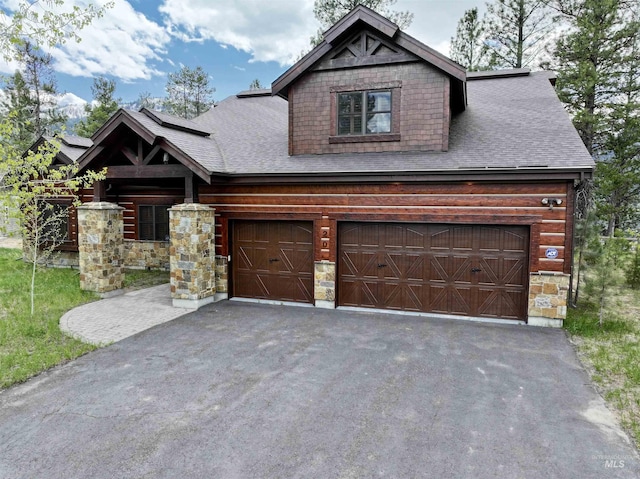 20 Shore Crest Ct, Donnelly, ID 83615 - view of front of home with driveway, a shingled roof, stone siding, and a garage