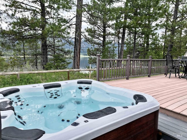 20 Shore Crest Ct, Donnelly, ID 83615 - deck featuring an outdoor hot tub, view of scattered trees, and a water view