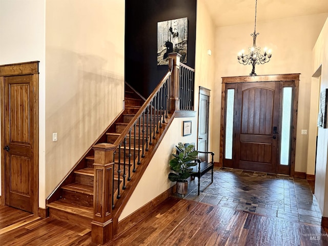 20 Shore Crest Ct, Donnelly, ID 83615 - entrance foyer featuring baseboards, a chandelier, a high ceiling, stairway, and wood finished floors