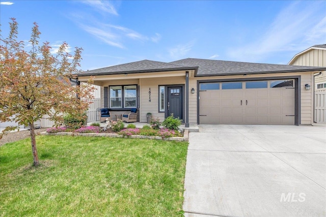 view of front of home featuring a porch, driveway, an attached garage, and a front lawn