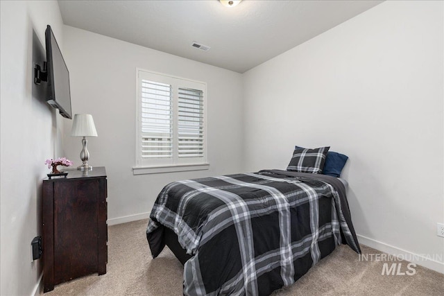 carpeted bedroom featuring baseboards