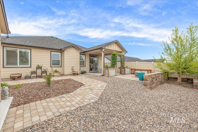 back of property featuring a patio area, fence, and roof with shingles