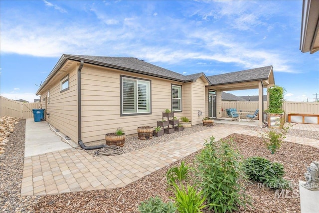 back of property with a patio area and a fenced backyard