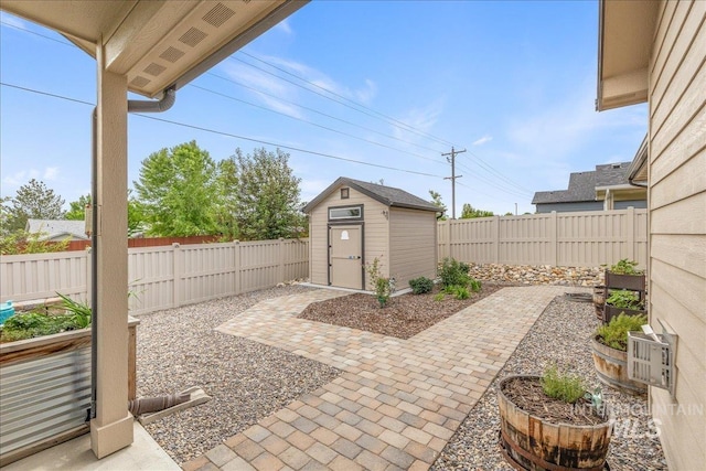 view of patio / terrace featuring a shed, an outbuilding, and a fenced backyard