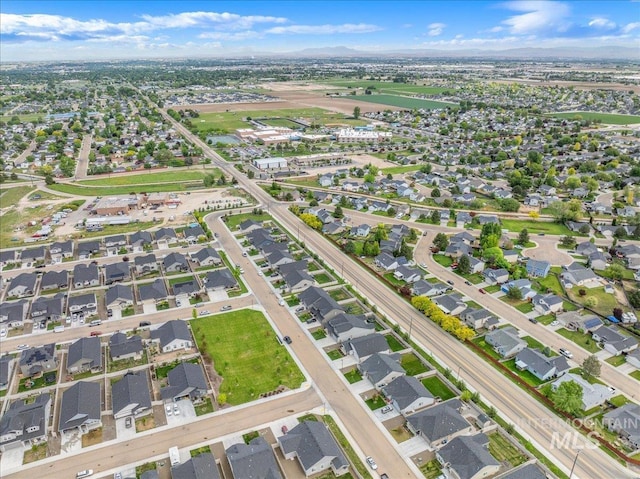 aerial view of property's location featuring nearby suburban area and mountains