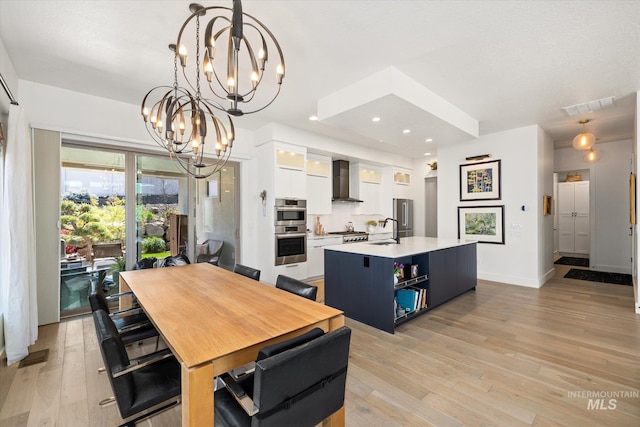 dining room with a notable chandelier, recessed lighting, baseboards, light wood-type flooring, and visible vents