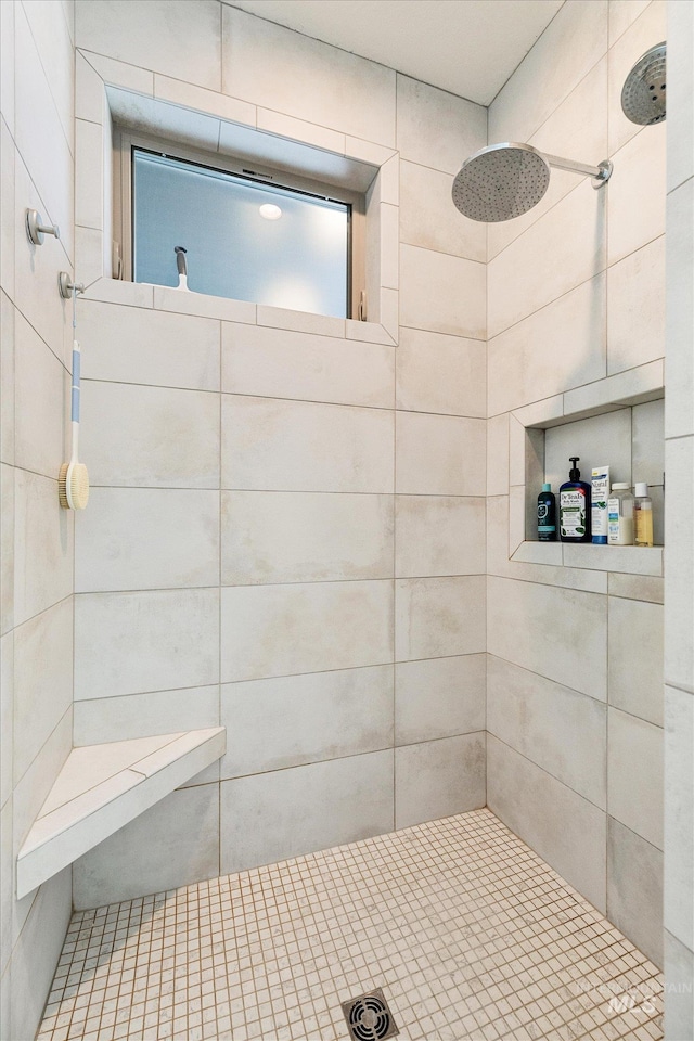 bathroom with a tile shower