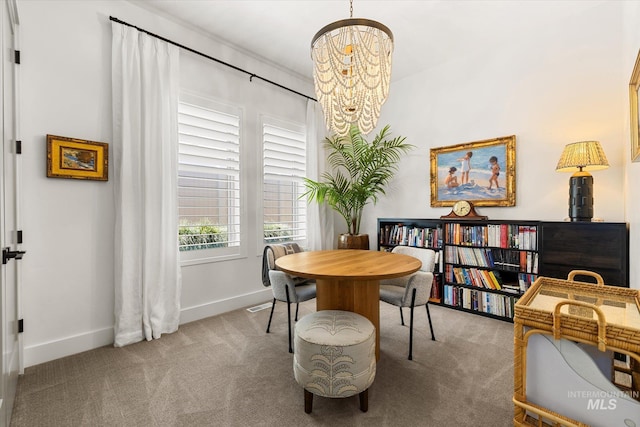 carpeted dining space with baseboards, a notable chandelier, and visible vents