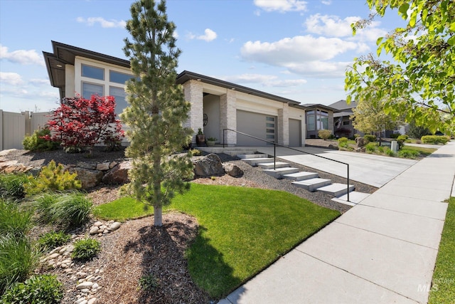 view of front of house featuring fence, driveway, a front lawn, and a garage