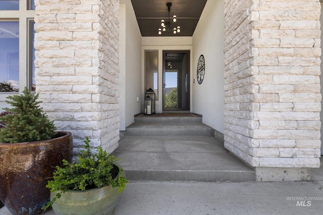 view of exterior entry with stucco siding