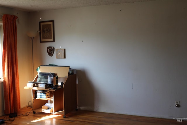 interior space featuring a textured ceiling and hardwood / wood-style flooring