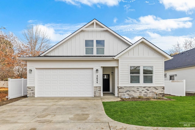 view of front facade with driveway, a garage, fence, board and batten siding, and brick siding