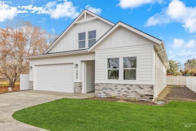 view of front of home with stone siding, board and batten siding, concrete driveway, and a front yard