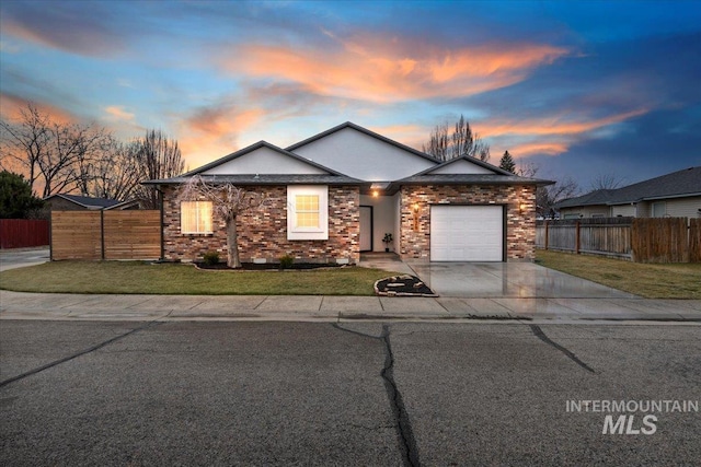 ranch-style house with stucco siding, a lawn, driveway, fence, and a garage