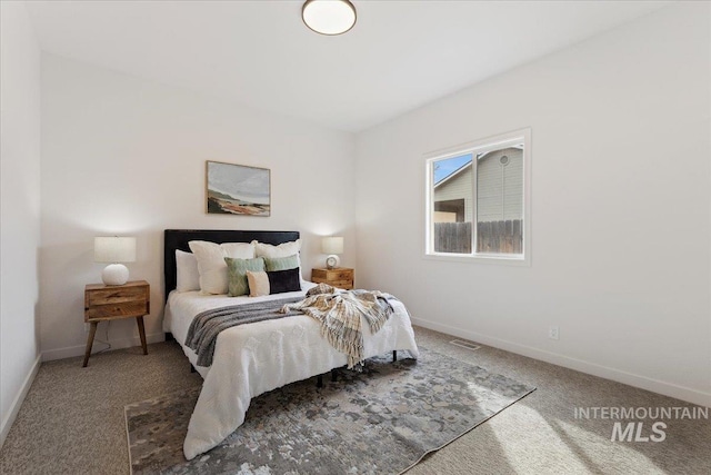 bedroom featuring baseboards, visible vents, and carpet floors