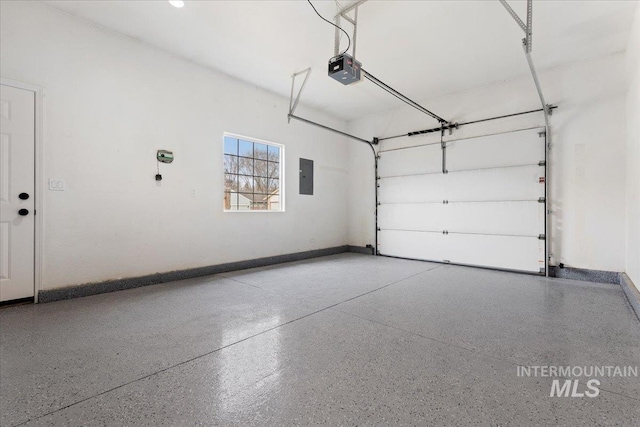 garage featuring electric panel, baseboards, and a garage door opener