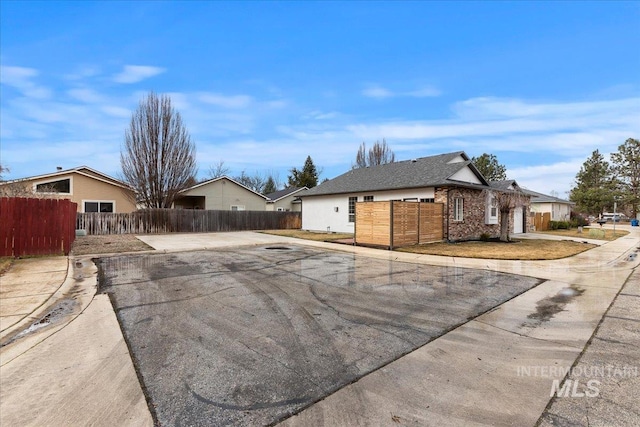 exterior space featuring a fenced front yard and driveway