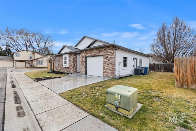 view of front facade with driveway, central AC, fence, a front yard, and brick siding