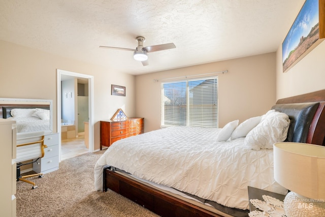 carpeted bedroom featuring ceiling fan, connected bathroom, and a textured ceiling