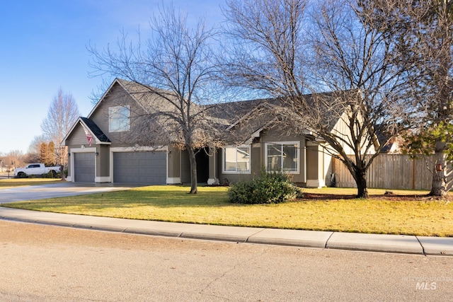 view of front of house featuring a garage and a front lawn