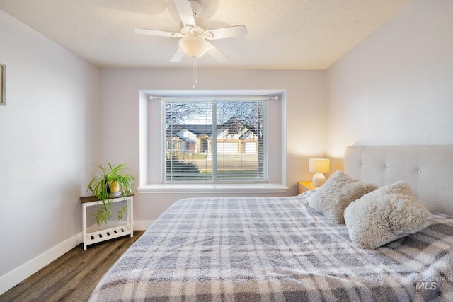 bedroom featuring dark hardwood / wood-style flooring and ceiling fan