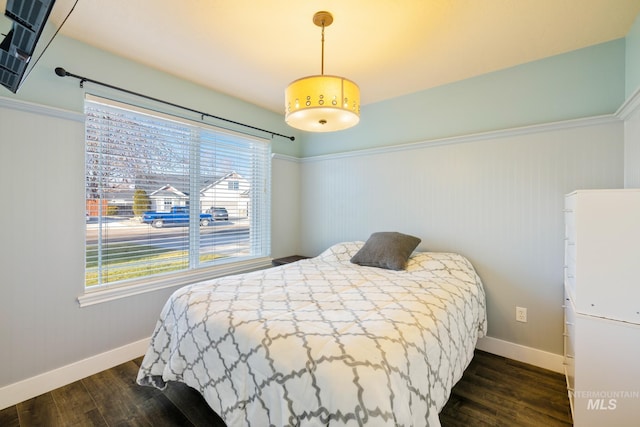 bedroom with dark wood-type flooring