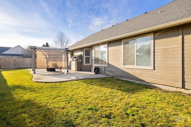 rear view of property featuring a yard and a patio area