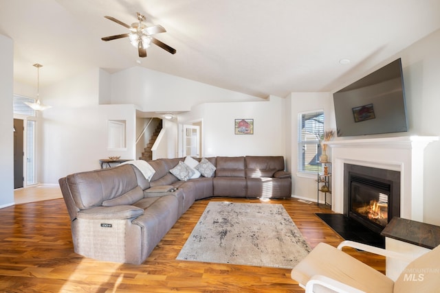 living room featuring ceiling fan, high vaulted ceiling, and light hardwood / wood-style floors