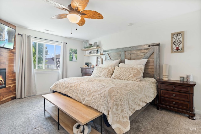 1509 N Cedar St, Jerome, ID 83338 - carpeted bedroom featuring a warm lit fireplace, baseboards, and a ceiling fan
