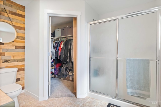 1509 N Cedar St, Jerome, ID 83338 - bathroom with wooden walls, a shower stall, toilet, baseboards, and a spacious closet