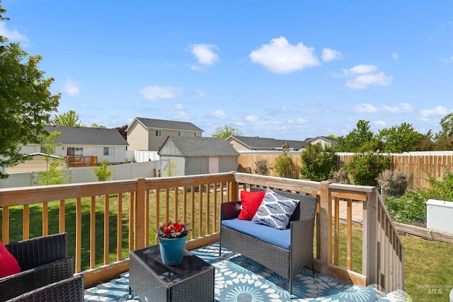 1509 N Cedar St, Jerome, ID 83338 - wooden deck featuring an outdoor structure, a storage unit, and a residential view