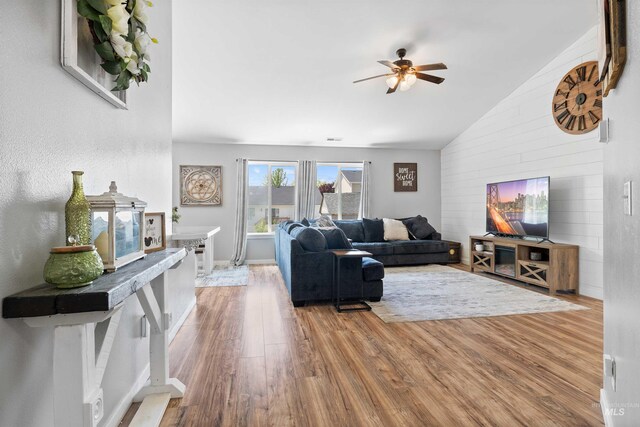 1509 N Cedar St, Jerome, ID 83338 - living room featuring vaulted ceiling, ceiling fan, wood finished floors, and wooden walls