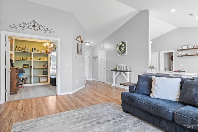 1509 N Cedar St, Jerome, ID 83338 - living area featuring wood finished floors, a chandelier, baseboards, and high vaulted ceiling