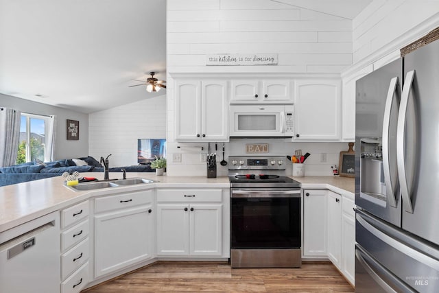 1509 N Cedar St, Jerome, ID 83338 - kitchen with appliances with stainless steel finishes, a sink, a ceiling fan, light countertops, and white cabinets