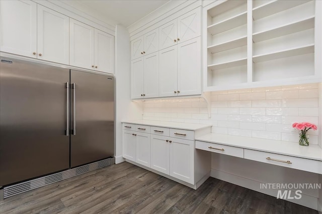 kitchen featuring open shelves, backsplash, stainless steel built in refrigerator, and light countertops